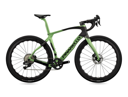 Lateral view of Pinarello Grevil F9 gravel bike, showcasing aerodynamic frame and Vittoria Terreno DRY TNT tires.