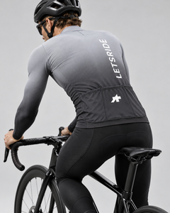 Approved Club Spring/Fall S11 Ice Grey jersey worn by road cyclist — rear riding view