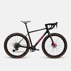 Nich KEM gravel bike by Approved Cycling, action shot on a fire road, demonstrating stability and speed.