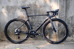 Nich Legend frame with included bottle cages, showcasing practical integration for long-distance road rides.