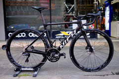 Underside view of Nich Legend carbon frame, revealing meticulous craftsmanship and internal cable routing.