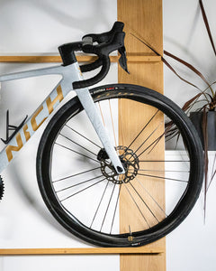 Close-up of Nich Legends 4 carbon road bike frame, showcasing weave and matte finish detail.