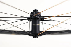Studio shot of Approved Cycling ATEM SilkRoad 3.8 front wheel, emphasizing the deep aerodynamic profile.