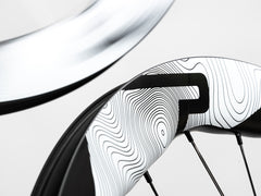 Dynamic shot of Princeton CarbonWorks Dual 5550 Evolution wheels in motion, blurring speed.