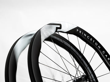 A pair of Princeton CarbonWorks Dual 5550 Evolution wheels, ready for competitive cycling.
