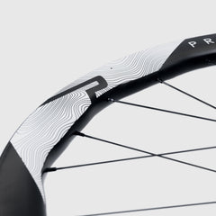 Dynamic shot: Princeton CarbonWorks Grit 4540 Evolution wheelset in motion, blurring speed.