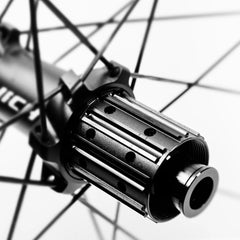 Approved Cycling NICH Atem 4S carbon road bike wheels, 60mm depth, mounted on a modern road bike, ready for speed.